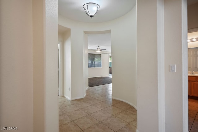 hall featuring light tile patterned floors