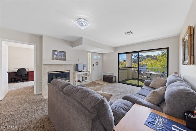 living room with light colored carpet and a fireplace