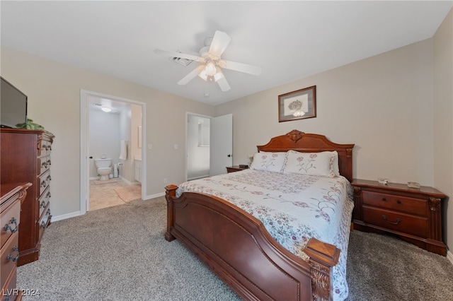 carpeted bedroom with connected bathroom and ceiling fan