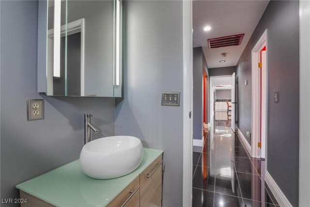 bathroom with tile patterned floors and vanity