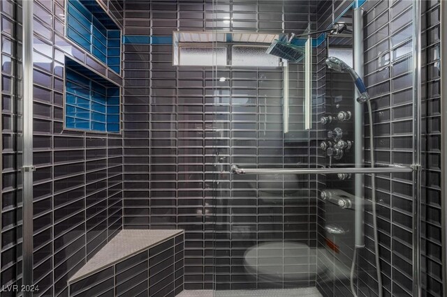 bathroom featuring a shower with door