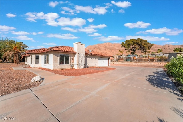 view of front of home featuring a garage and a mountain view