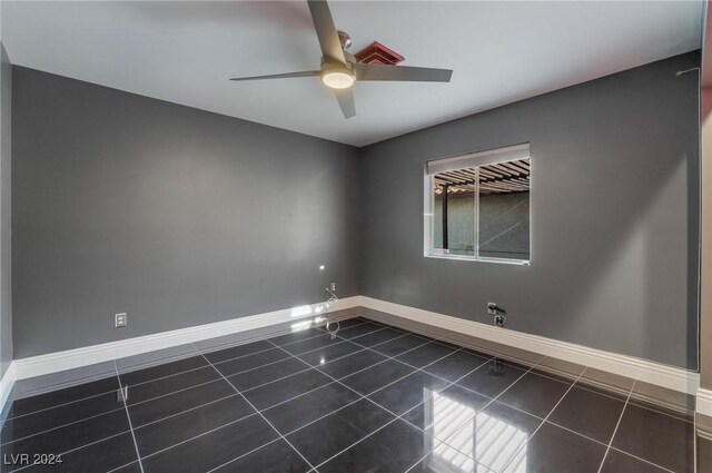 tiled empty room featuring ceiling fan