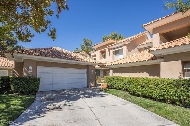 mediterranean / spanish home featuring a garage