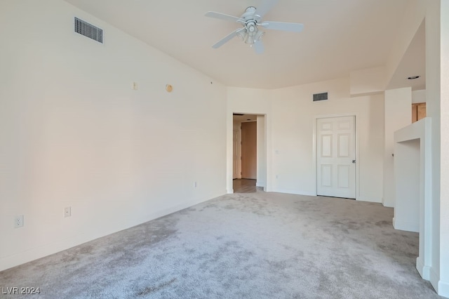 carpeted spare room featuring ceiling fan