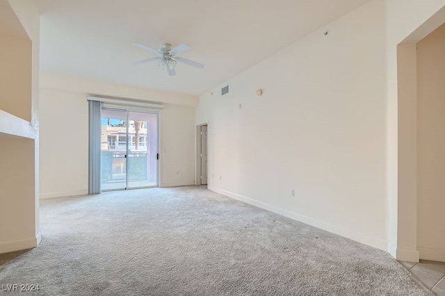 unfurnished room featuring light carpet and ceiling fan