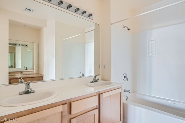 bathroom with shower / bathing tub combination and vanity