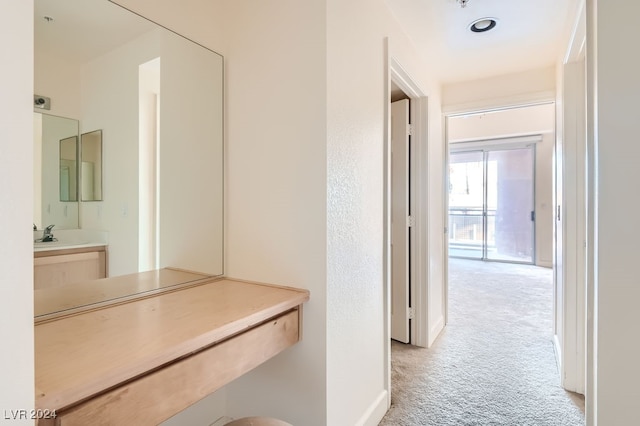 corridor with light colored carpet