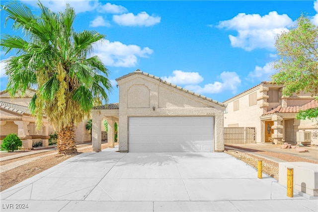 mediterranean / spanish home with a garage