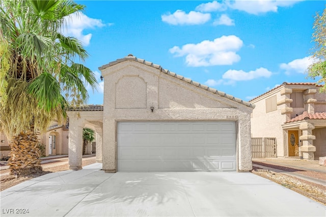 mediterranean / spanish-style house featuring a garage