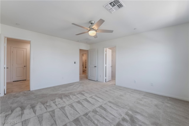 empty room featuring light carpet and ceiling fan