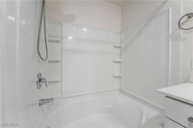 bathroom featuring  shower combination and vanity