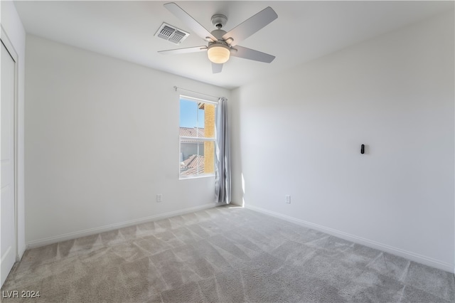 unfurnished room featuring light colored carpet and ceiling fan