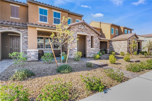 view of front of home with stone siding and stucco siding