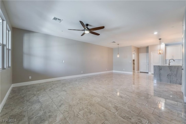 unfurnished living room featuring ceiling fan