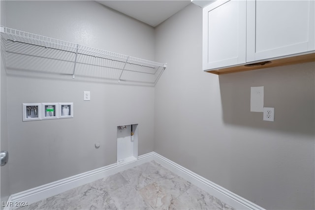 washroom with gas dryer hookup, hookup for a washing machine, cabinets, and hookup for an electric dryer