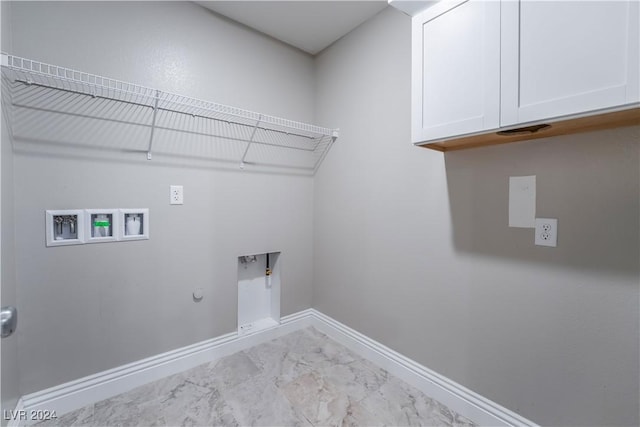 washroom featuring cabinet space, baseboards, gas dryer hookup, hookup for a washing machine, and marble finish floor