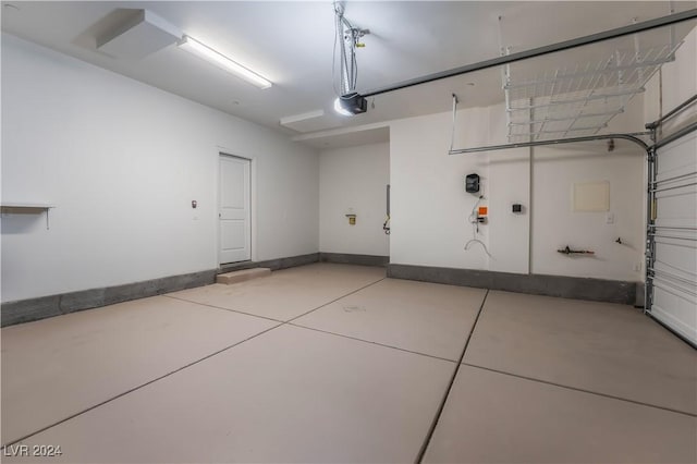 garage with a garage door opener and baseboards