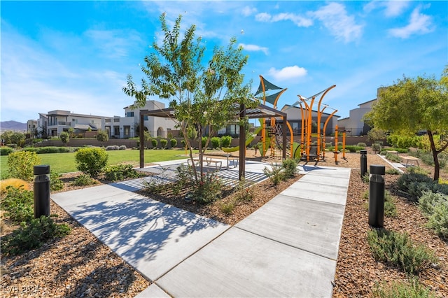 view of community featuring a residential view, playground community, and a yard