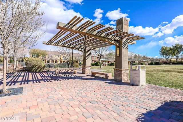 view of property's community with a lawn, a patio area, and a pergola