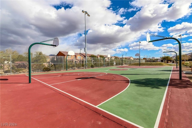 view of basketball court with community basketball court and fence