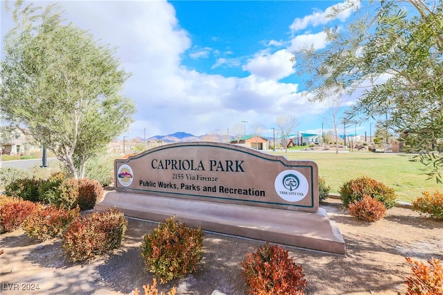 community sign featuring a lawn