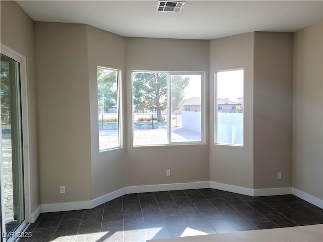 empty room featuring dark tile patterned floors