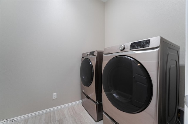 clothes washing area featuring light tile patterned flooring and independent washer and dryer