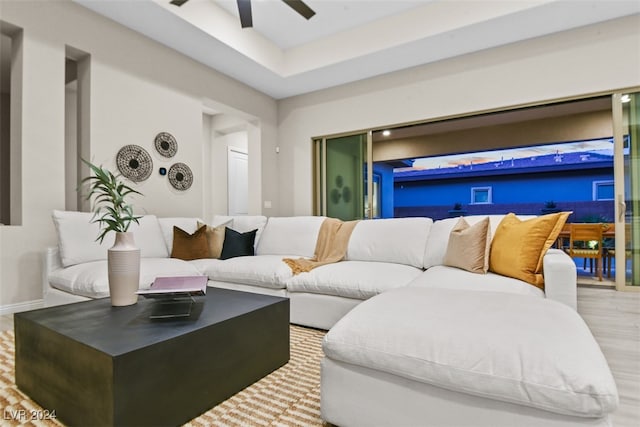 living room with ceiling fan and light hardwood / wood-style flooring