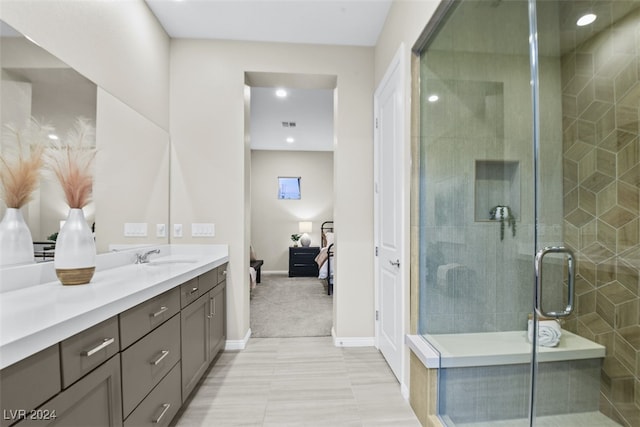 bathroom with vanity, tile patterned floors, and a shower with shower door