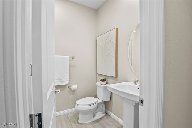 bathroom featuring toilet and hardwood / wood-style floors