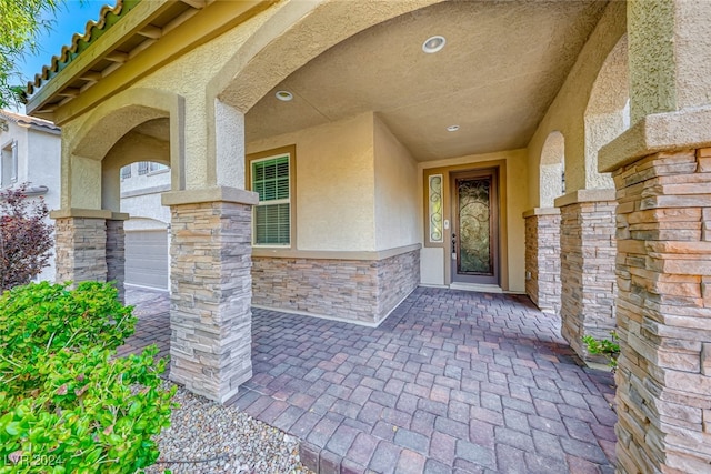 doorway to property with a garage