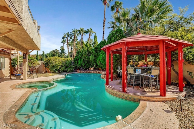 view of pool featuring a patio, a gazebo, and an in ground hot tub