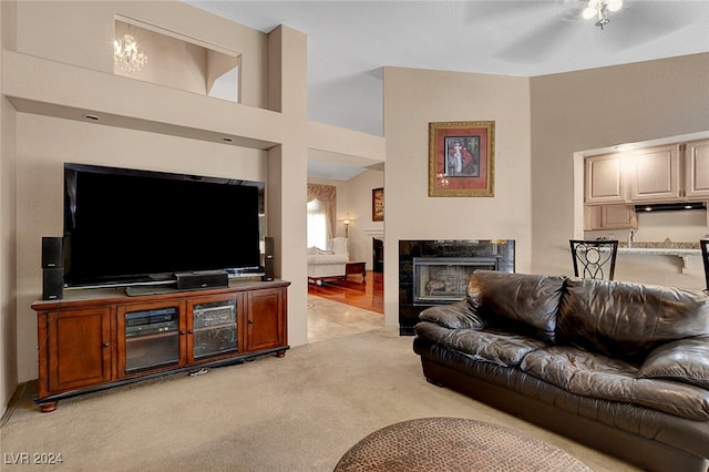 carpeted living room with a tile fireplace and ceiling fan