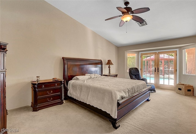 bedroom featuring ceiling fan, lofted ceiling, french doors, light carpet, and access to exterior