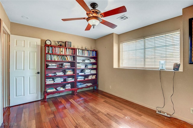 interior space featuring wood-type flooring and ceiling fan