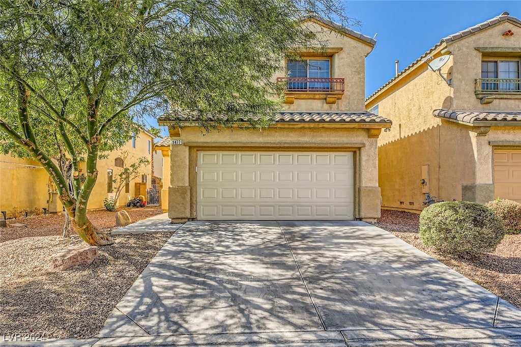 mediterranean / spanish house with a garage