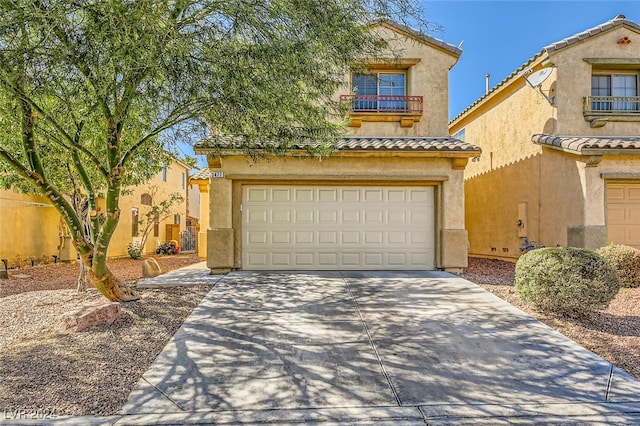 mediterranean / spanish house with a garage