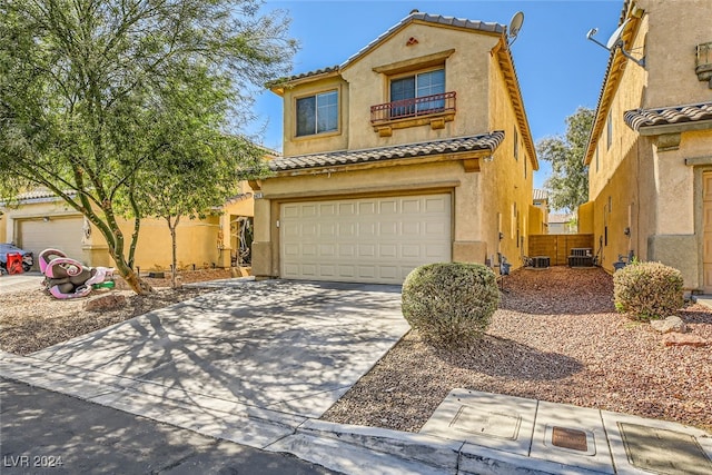 mediterranean / spanish-style home with a garage and central AC