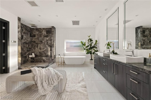 bathroom with a freestanding tub, visible vents, vanity, and tiled shower