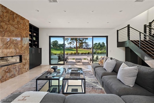 living room featuring built in shelves, recessed lighting, marble finish floor, and visible vents