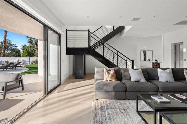 living room featuring visible vents and stairway