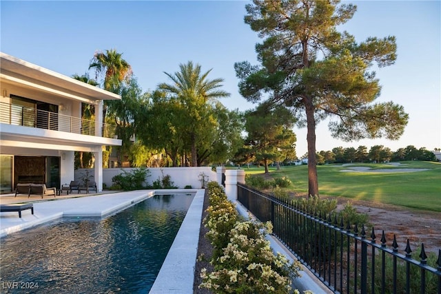 view of pool with a fenced in pool, a patio area, fence, and a lawn