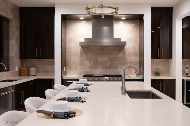 kitchen featuring modern cabinets, light countertops, a sink, and extractor fan