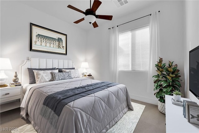 bedroom with baseboards, visible vents, ceiling fan, and carpet