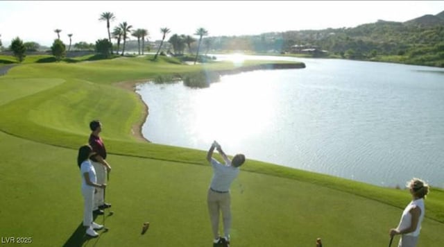 view of community with view of golf course and a water view