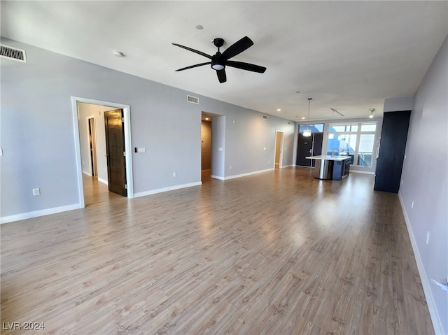 unfurnished living room featuring light hardwood / wood-style flooring and ceiling fan