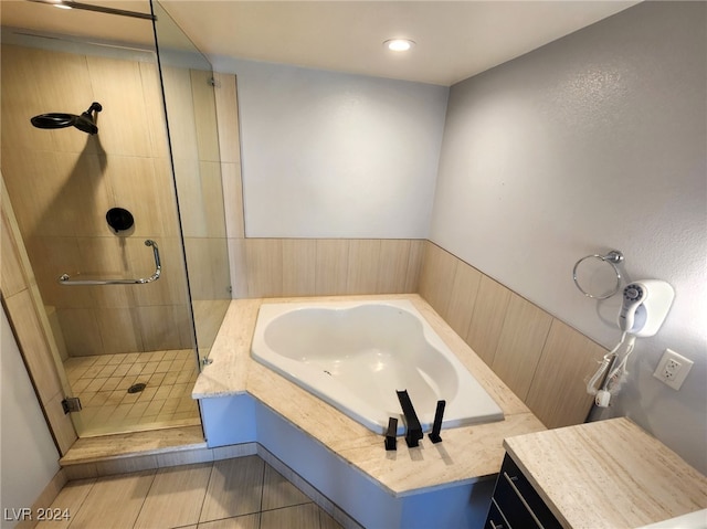 bathroom featuring independent shower and bath, tile patterned flooring, and vanity