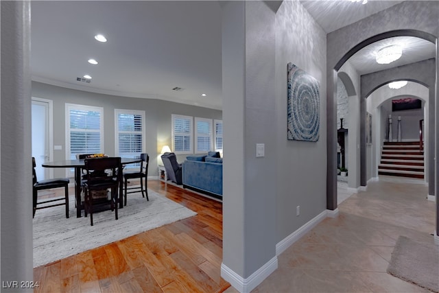 interior space featuring ornamental molding and light wood-type flooring