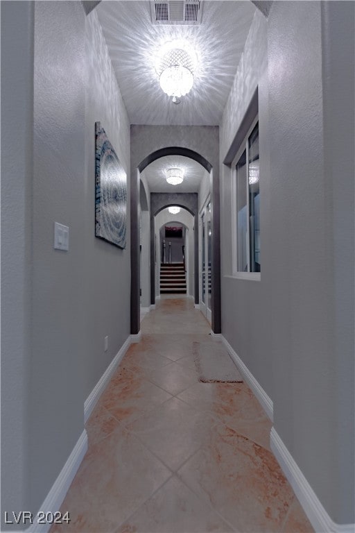 corridor with light tile patterned floors